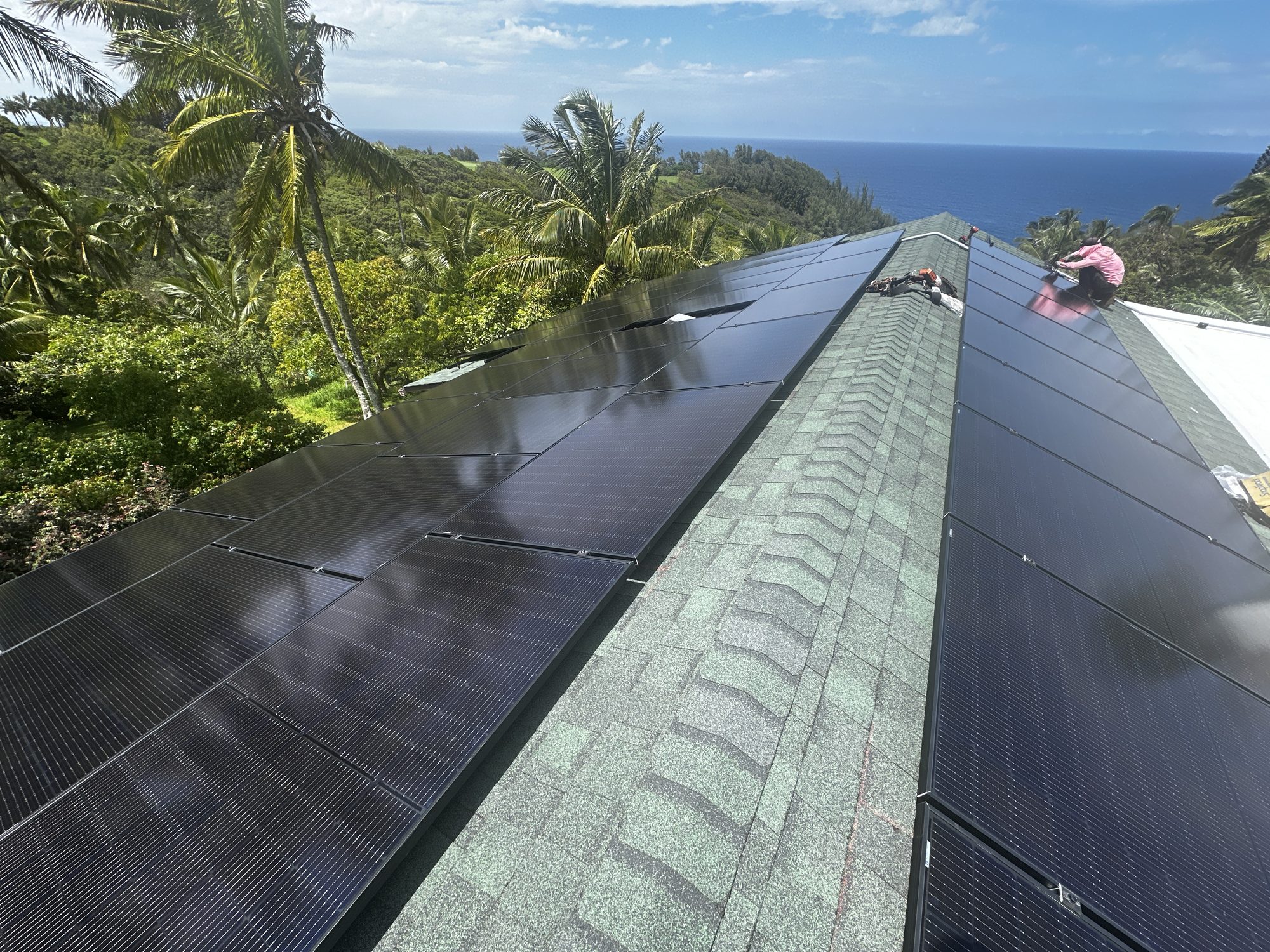 Solar panels installed on a Maui rooftop overlooking the ocean